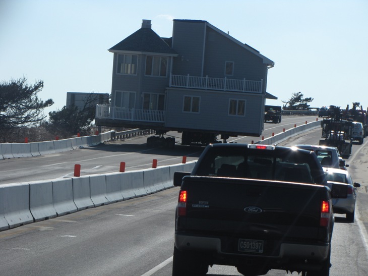 large house being transported by tractor trailer along the coast of Delaware