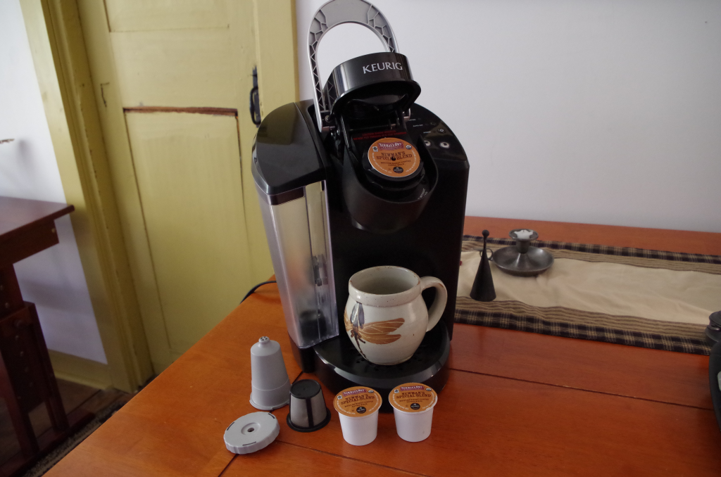 Image of a Keurig single serve coffee maker, with pre-packaged and reusable pods.